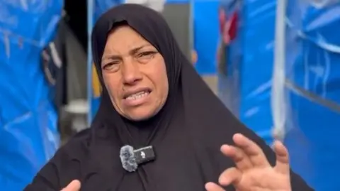 Displaced Palestinian Jamalat Wadi speaks to the BBC at a tent camp in Deir al-Balah, central Gaza (5 February 2025)