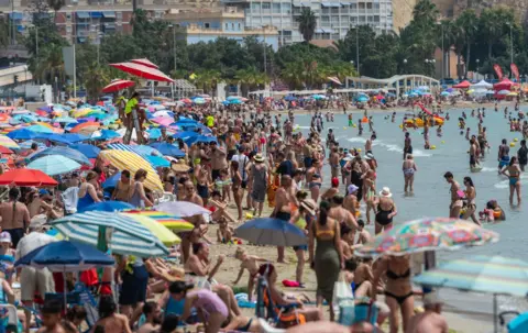 Getty Images A packed beach at Alicante in Valencia