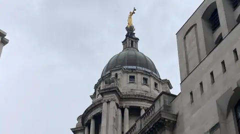 Brian Farmer/BBC The outside of the Old Bailey court in London. The camera is pointing upwards towards the building.