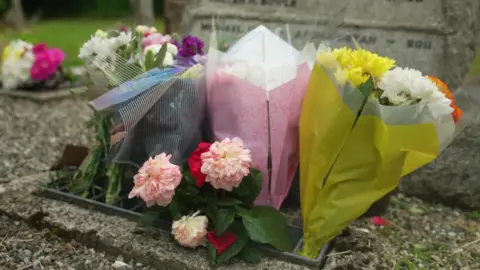 Floral tributes left outside All Saints Church in Okehampton on Sunday afternoon. 