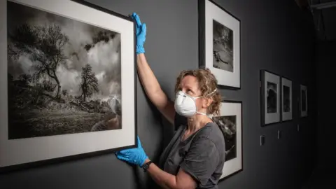 Paul Cooper/pcooperphoto.com Art handling manager Jenny Hunter installing the Don McCullin exhibition at Tate Liverpool