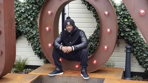A man sitting on a large metal sculpture