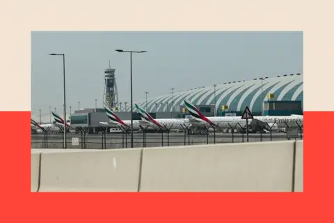 AFP via Getty Images Emirates airline planes are parked on the tarmac at Dubai International Airport