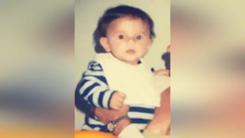 Oliver Archer Oliver Archer as a young child. He wears a striped top and a white bib. 