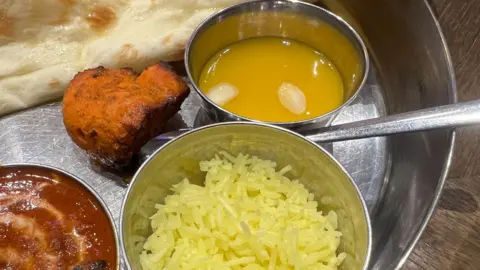 Getty Images A bowl of mango pulp as part of an Indian thali - a meal made up of various components and served on a platter
