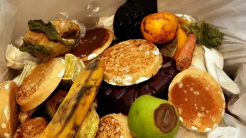 BBC Contents of a food waste caddy - mouldy bread and rotting bananas and apples