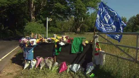 Flowers tributes on the side of the road between Caernarfon and Caeathro