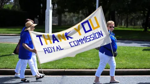 Reuters Women hold a banner thanking the Royal Commission into institutional child sexual abuse