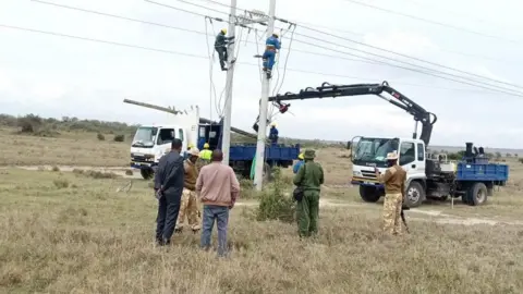 Kenya Wildlife Service Representatives from KWS examine the power lines