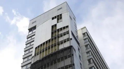 Getty Images A tower in Islington missing a portion of its cladding