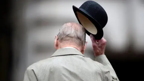 Prince Philip raises his hat