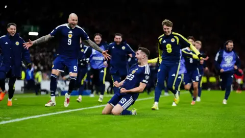 Kenny McLean celebrates sending Scotland to the 2026 World Cup with a win over Denmark.
