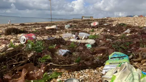 A beach with rubbish on