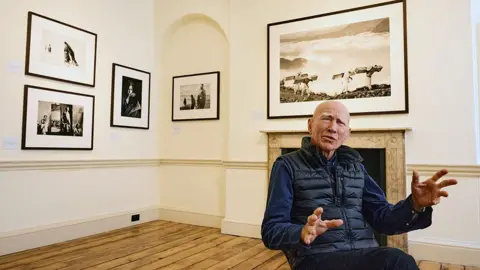 BENJAMIN CREMEL/AFP via Getty Images Brazilian photographer Sebastiao Salgado poses for a portrait at Somerset House, in London, on April 18, 2024.