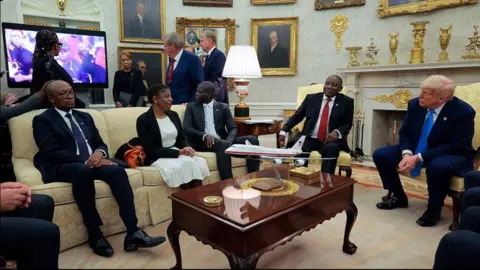 President of South Africa Cyril Ramaphosa (2nd-R) and US President Donald Trump (R) look on as a video plays in the Oval Office of the White House 