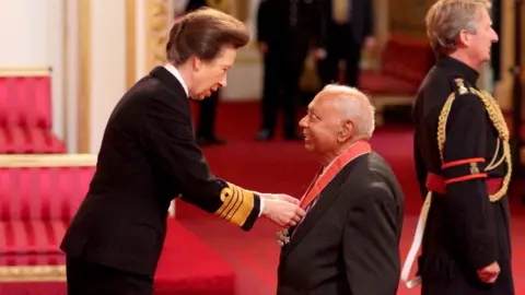 PA Media Dr Hari Shukla was made a CBE by the Princess Royal at Buckingham Palace