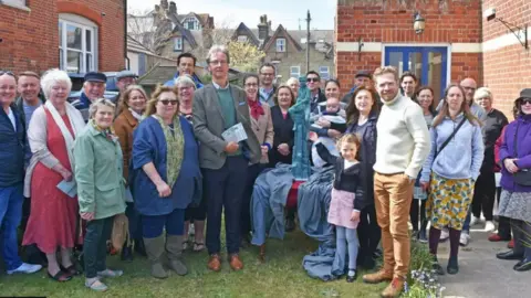 Mick Howes A group of people at the unveiling of the Britten as a Boy maquette