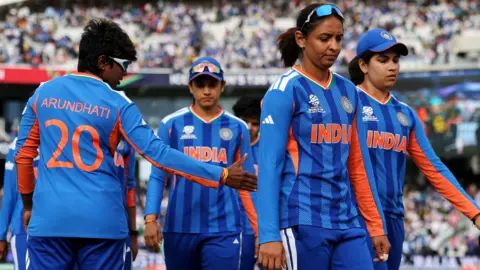 India's players, led by captain Harmanpreet Kaur, walk off looking glum