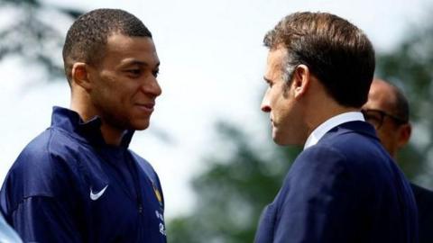 Kylian Mbappe speaks to French President Emmanuel Macron