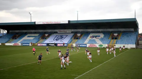 Getty Images A men's rugby league match takes place at Featherstone Rovers' Millennium Stadium. The players are in action.