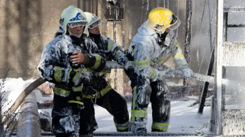 State Emergency Service Of Ukraine Firefighters enactment    astatine  the tract  of a captious  infrastructure installation  deed  by a Russian rocket  strike