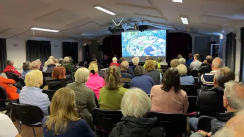 BBC Residents gathering for a meeting about a proposed housing development in Hatton