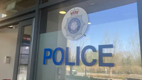 Nadia Lincoln/LDRS Northamptonshire's Police's logo imprinted on a glass door.