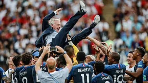Didier Deschamps is lifted into the air by his players after France win the World Cup in 2018