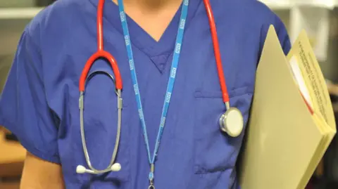 Generic torso image of a nurse in blue uniform with stethoscope and carrying a file