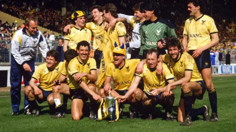 Oxford United v Queens Park Rangers at the Milk Cup Final on 20 April 1986, Oxford players and coach Ray Graydon celebrate with the trophy.