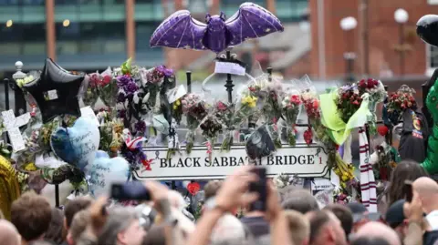 EPA image of Black Sabbath Bridge in Birmingham with fan's tributes