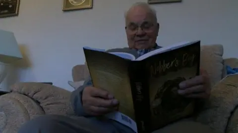 Royston "Roy" Mills with a copy of Nobber's Boy