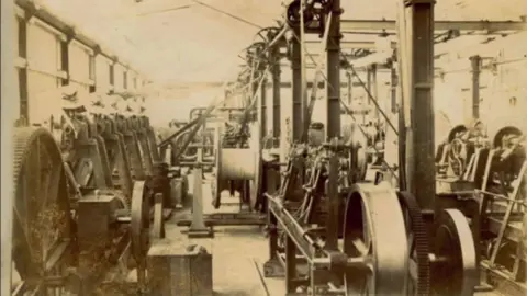 Cheshire Image Bank/Jim and Jennie Lloyd Rows and rows of cable equipment and machines are in operation in the factory.