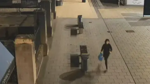 CCTV still of a person running through Broadmead in Bristol