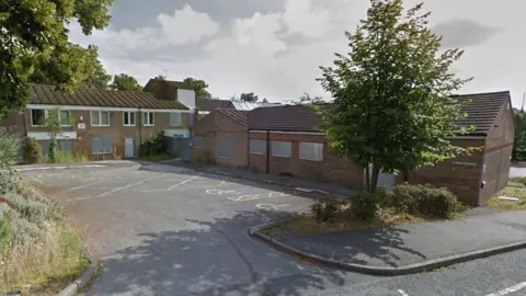 Google The former Pease Hill Centre - an NHS service centre - with boarded up windows, years after it closed.