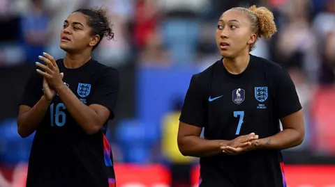 Jess Carter and Lauren James clapping the fans after an England game