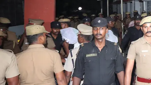 Reuters Police stand guard as the accused are brought to court in Chennai, India, July 17, 2018