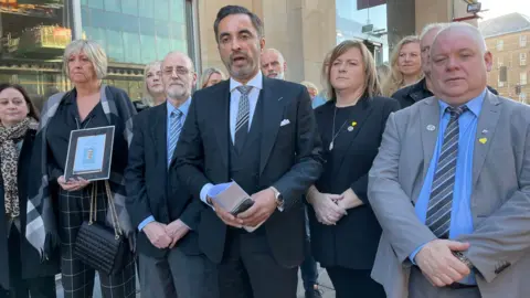 Members of the Scottish branch of the UK group Covid-19 Bereaved Families for Justice and solicitor Aamer Anwar