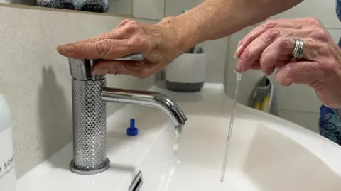 A reusable catheters being washed in a sink