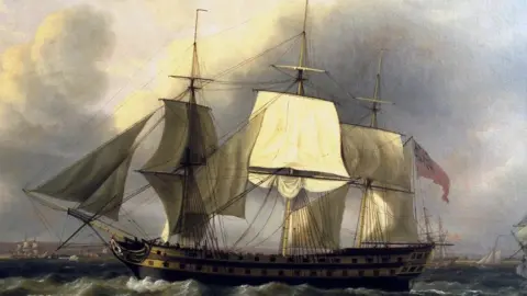Portland Museum Trust An artist's impression of the Earl of Abergavenny ship from the side. The body of the ship is mostly dark. The ship has multiple large white sails raised.
