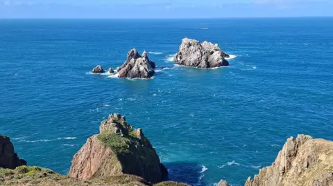 A wide shot of a collection of sea rocks off the north coast of the island.