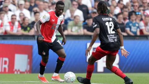Yankuba Minteh prepares to dribble at an Excelsior defender while playing for Feyenoord