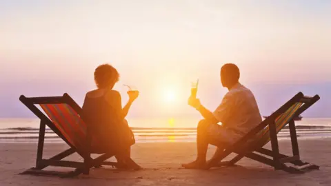 Getty Images Couple on beach in sun