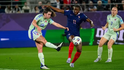 Esther Morgan kicking the ball against France 