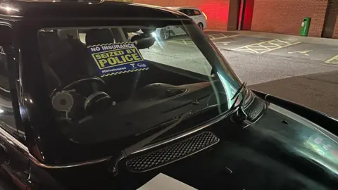 Kent Police A black car with a "No insurance, seized by police" notice on the windscreen