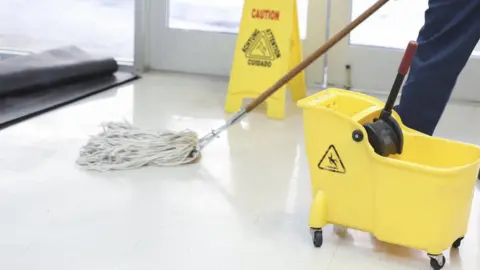 Getty Images A cleaner with a mop and bucket