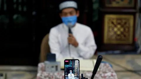 Reuters An imam in Indonesia broadcasts a recitation of the Koran