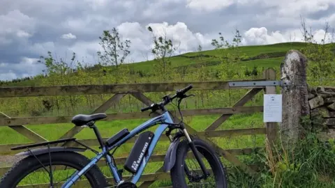 Gareth Cowin Bike propped up against gate