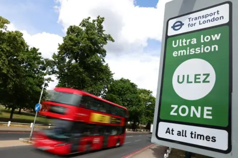 Reuters Bus in background, ULEZ sign in foreground