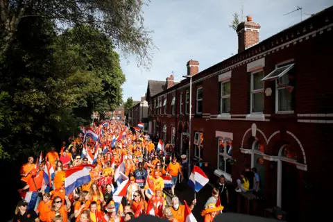 MOLLY DARLINGTON / Reuters Netherlands fans are seen outside the stadium before the match Leigh, Britain